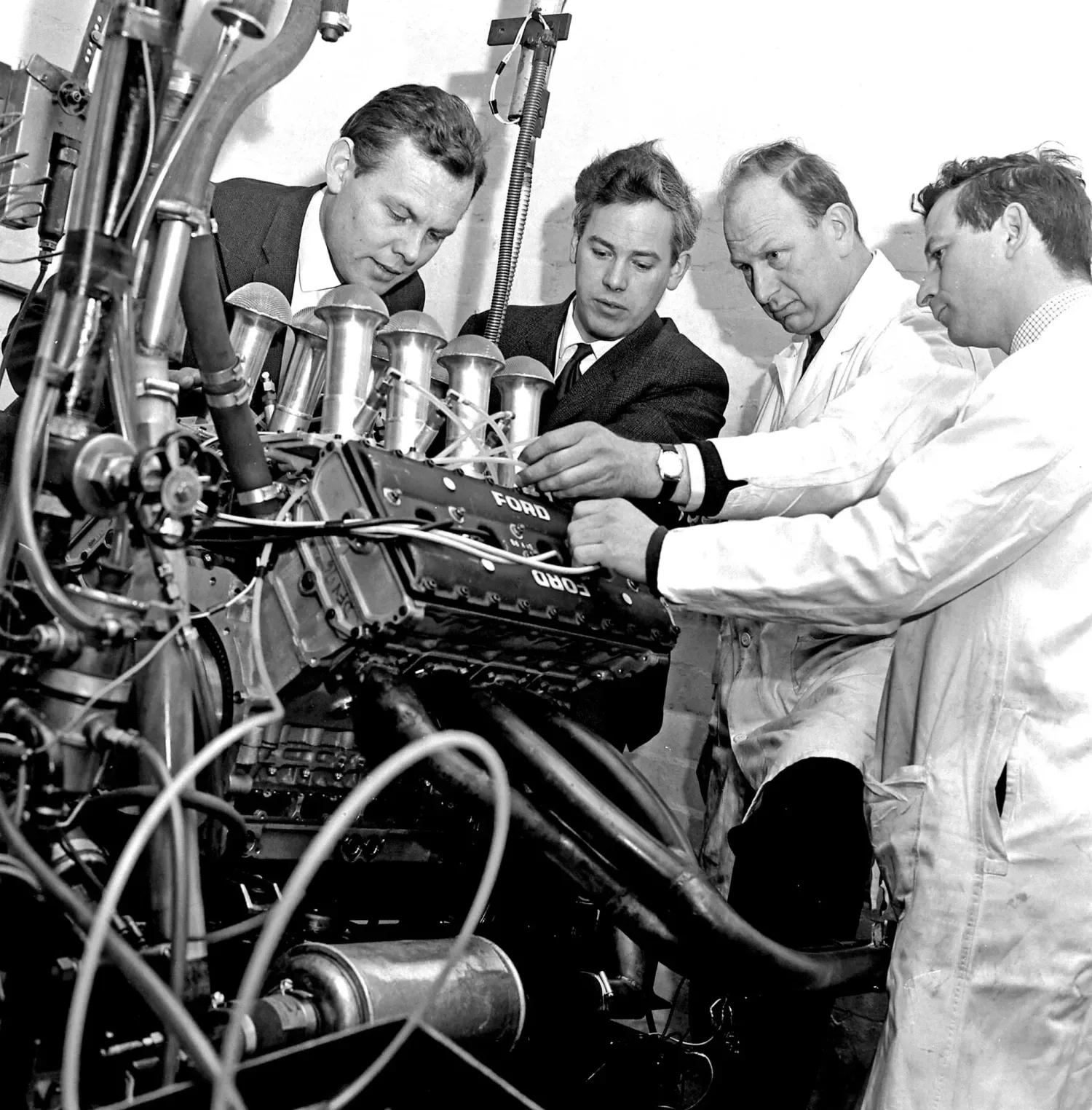 Mike Costin, Keith Duckworth and Cosworth engineers with the Ford Cosworth engine