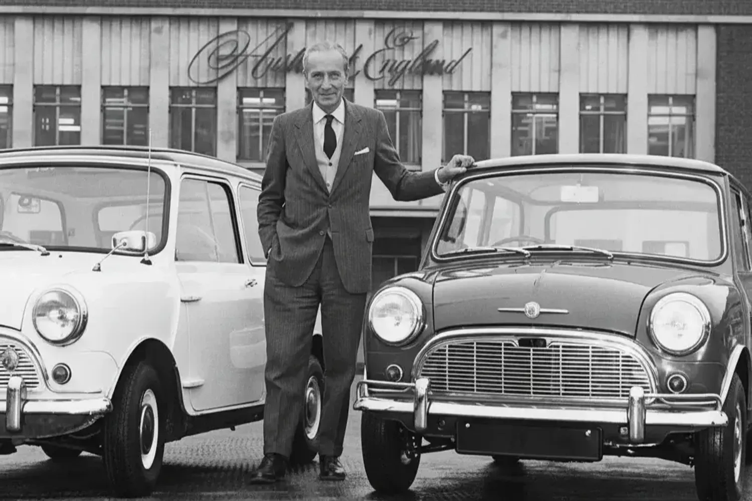 Sir Leonard Lord in front of the Austin Motor Company, Longbridge, with 
two early Minis (Image via Vintagepaparazzi.com)