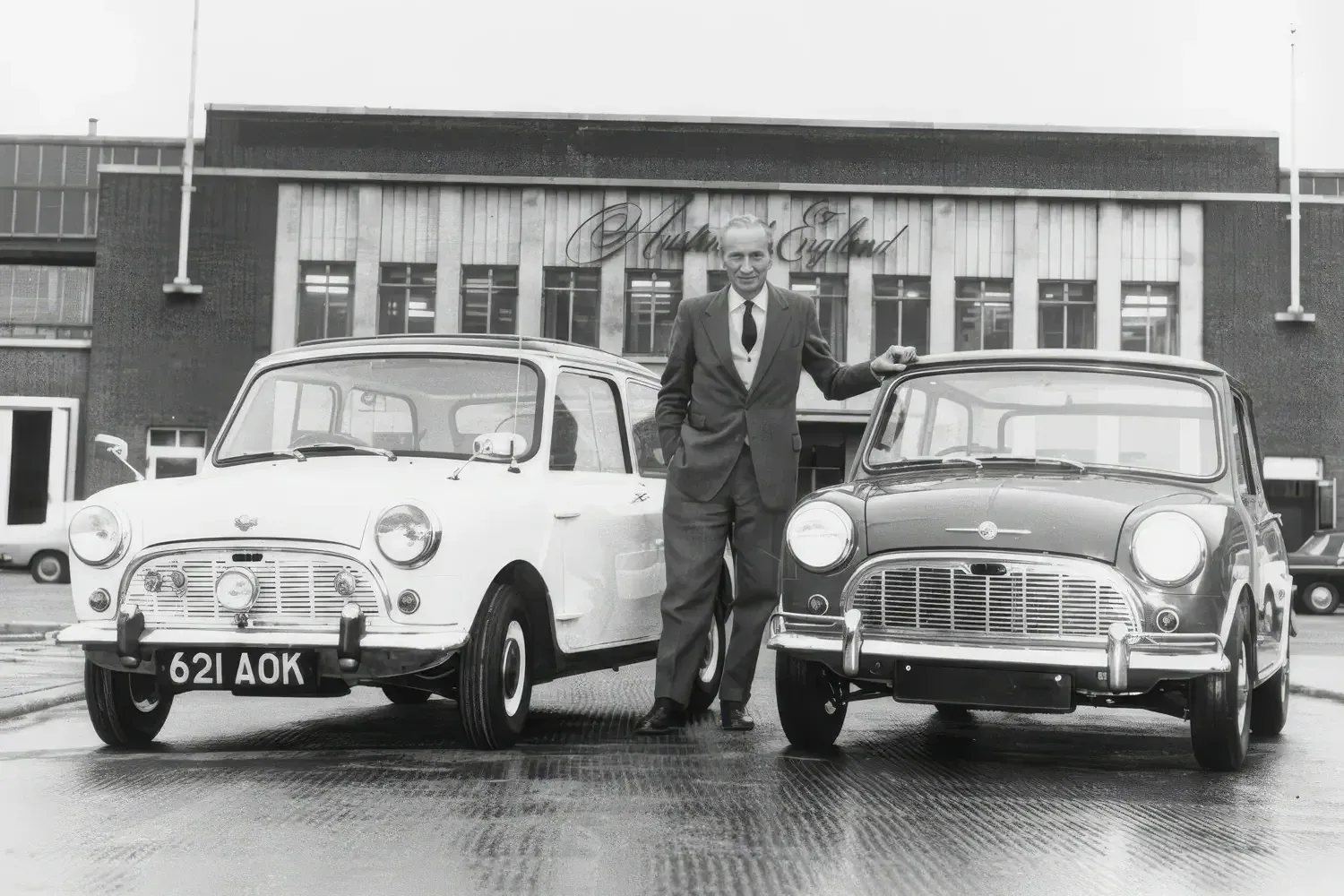 Alec Issigonis at Austin, Longbridge, standing next to the first Mini (621AOK) and a new 1965 Morris Mini Minor Deluxe (image via wikipedia.org)